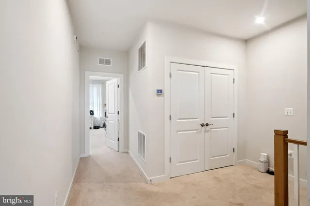 a bedroom with a bed and a flat tv screen on dresser