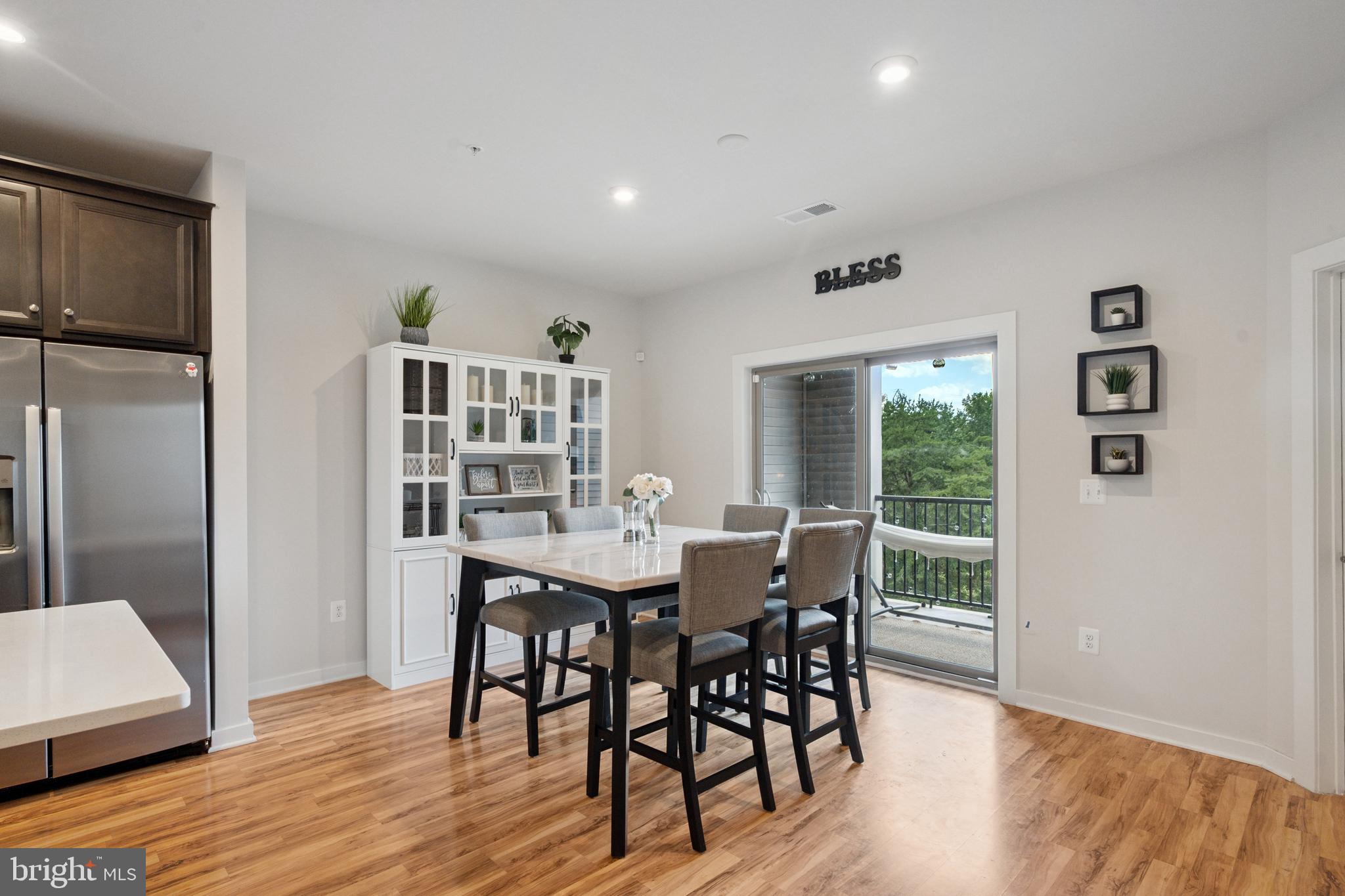 13506 Innovation Station Loop, Unit 2B Herndon, VA 20171 - Photo 6 of 32 a view of a dining room with furniture and wooden floor