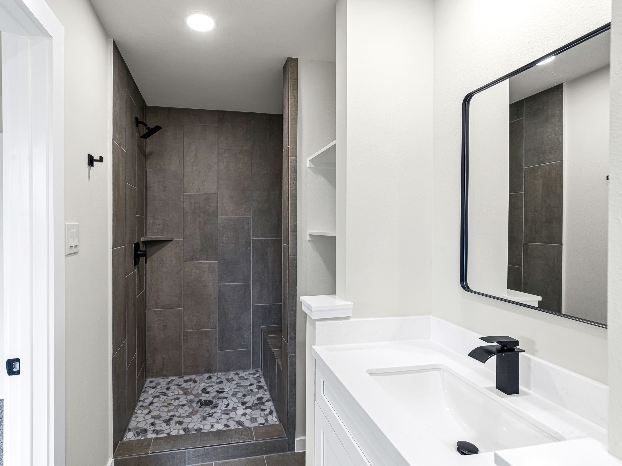1006 4th Street Hempstead, TX 77445 - Photo 25 of 29 a bathroom with a sink a shower and a mirror