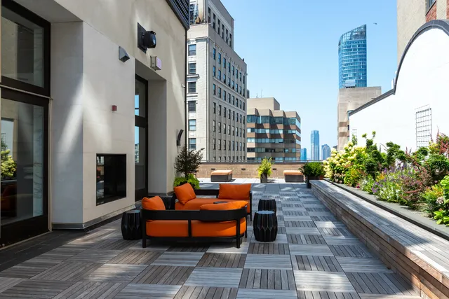a view of a patio with couches table and chairs and potted plants