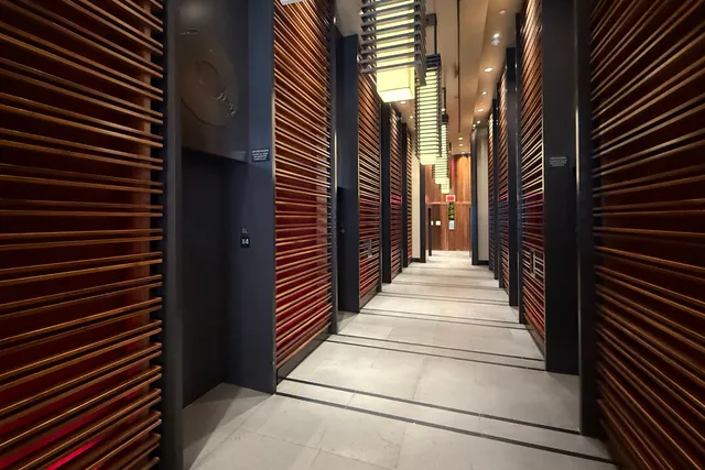 a living room with furniture and large windows