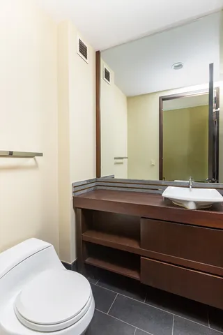 a bathroom with a double vanity sink and mirror