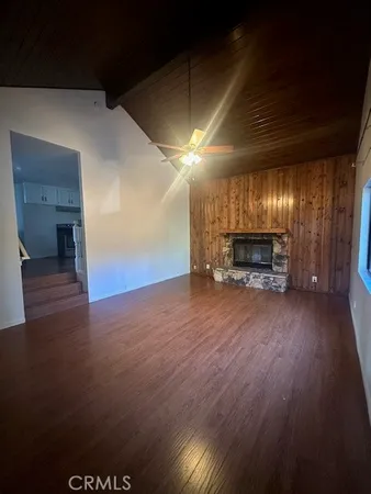 a view of a big room with wooden floor a fireplace
