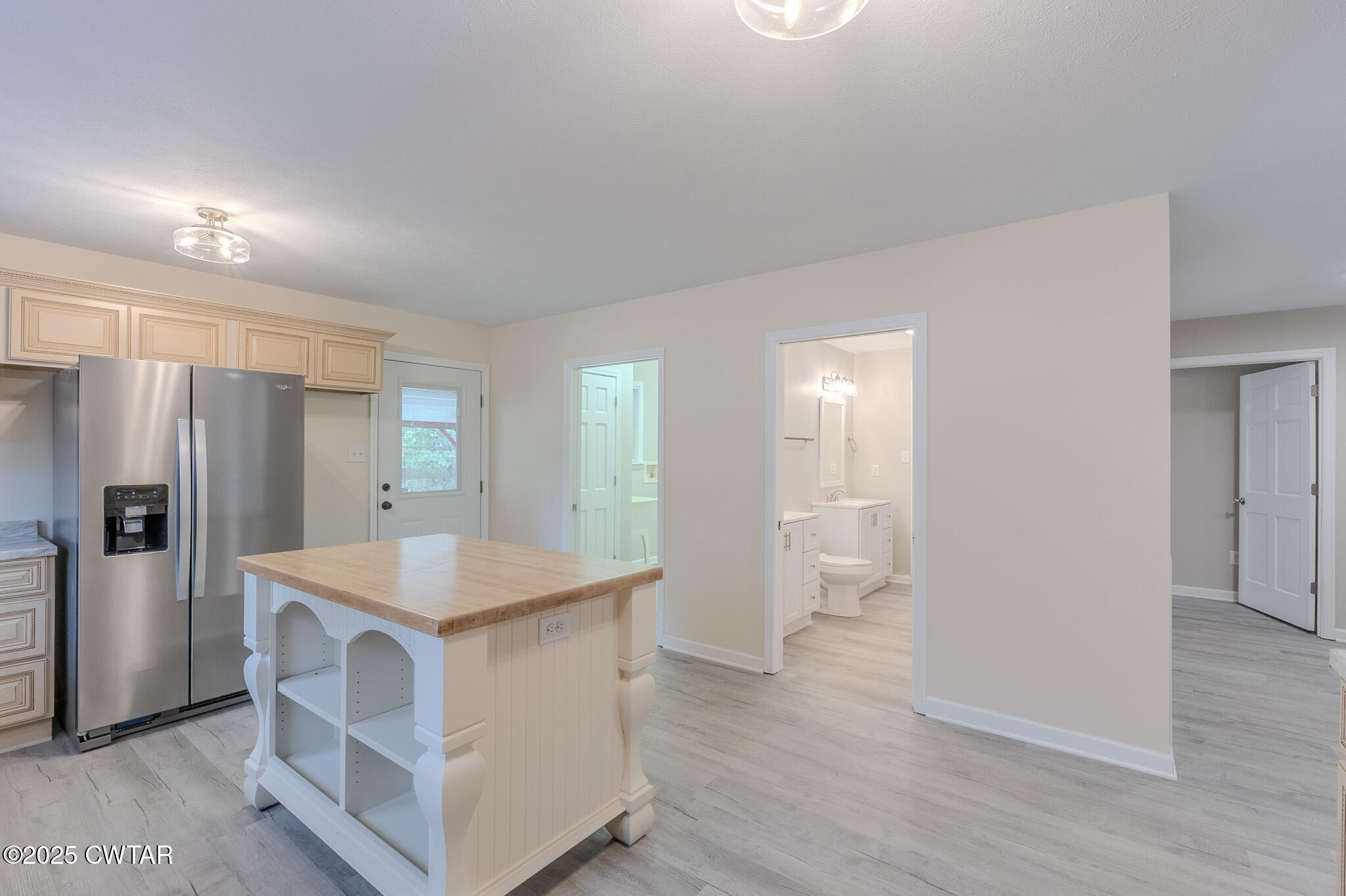 2850 Jeanette Holladay Road Parsons, TN 38363 - Photo 12 of 40 a view of kitchen with refrigerator stove and wooden cabinets