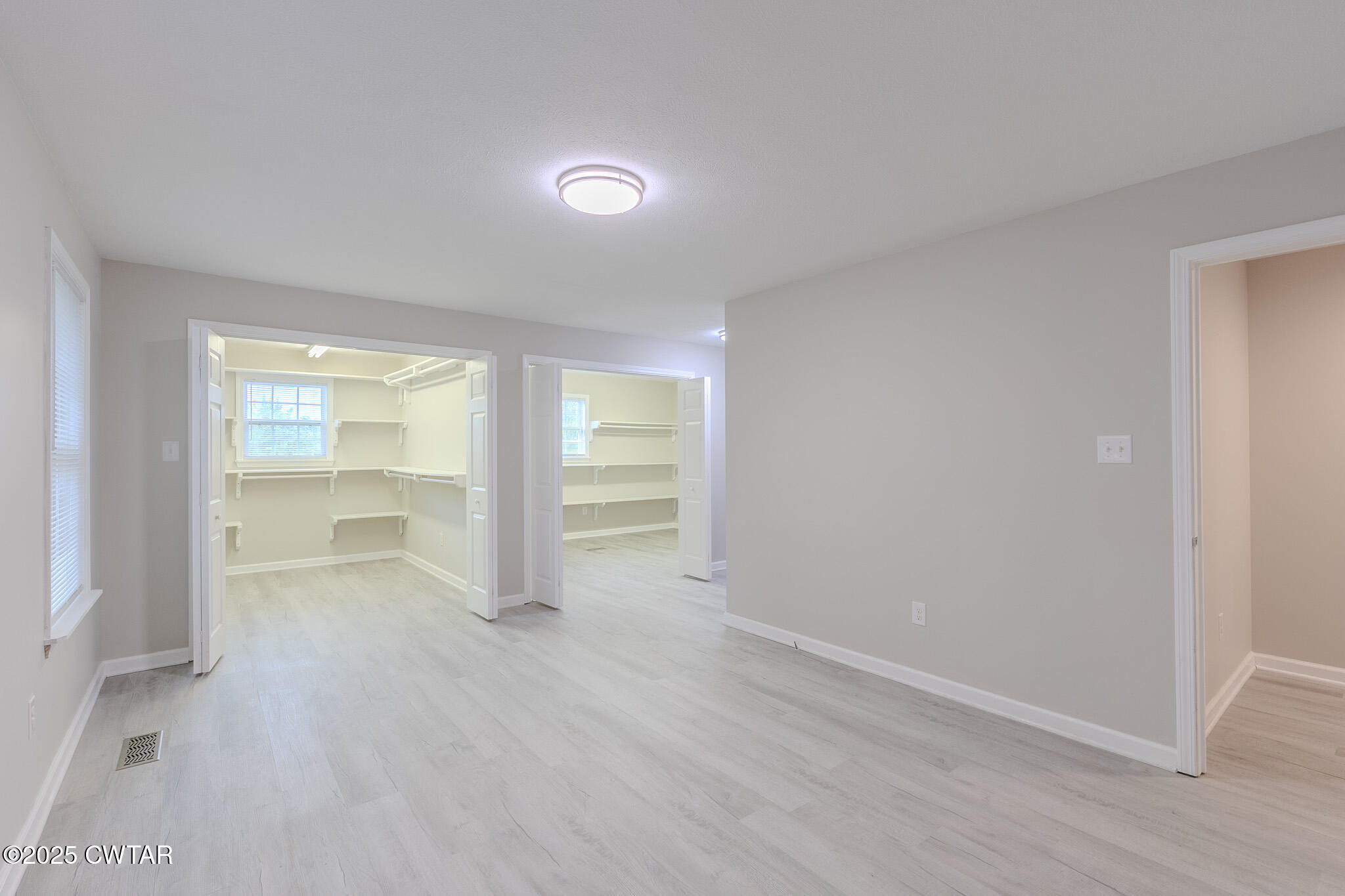 2850 Jeanette Holladay Road Parsons, TN 38363 - Photo 15 of 40 an empty room with wooden floor and windows