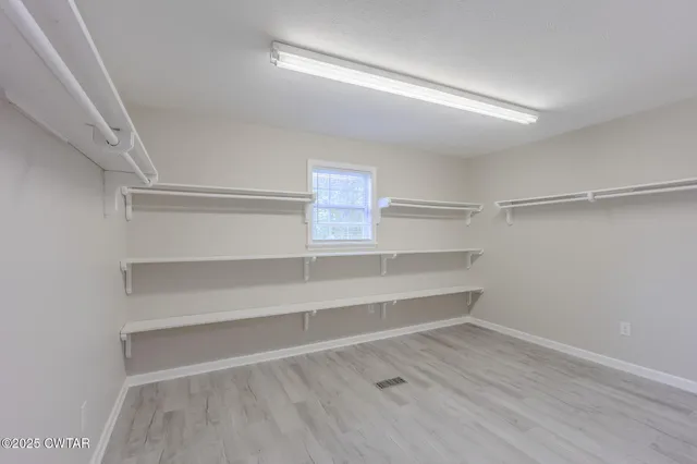 a view of an empty walk in closet