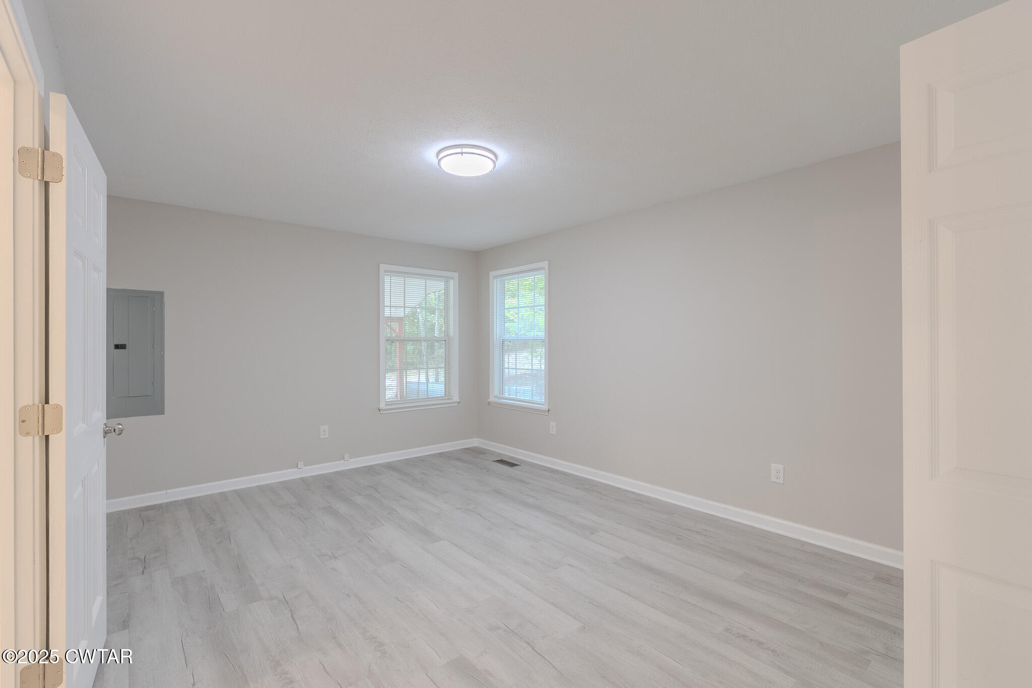 2850 Jeanette Holladay Road Parsons, TN 38363 - Photo 20 of 40 an empty room with wooden floor and windows