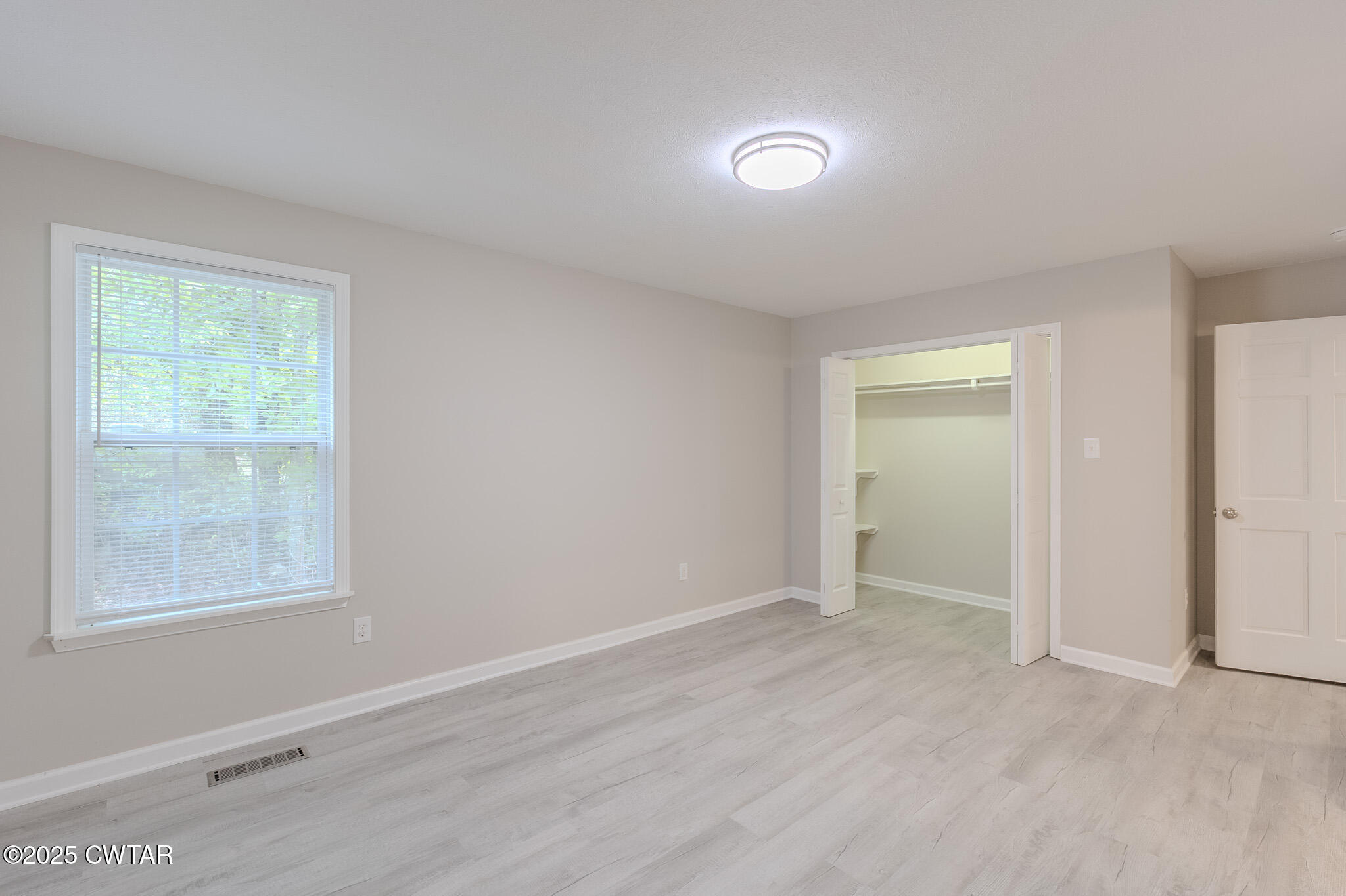 2850 Jeanette Holladay Road Parsons, TN 38363 - Photo 21 of 40 an empty room with wooden floor and windows