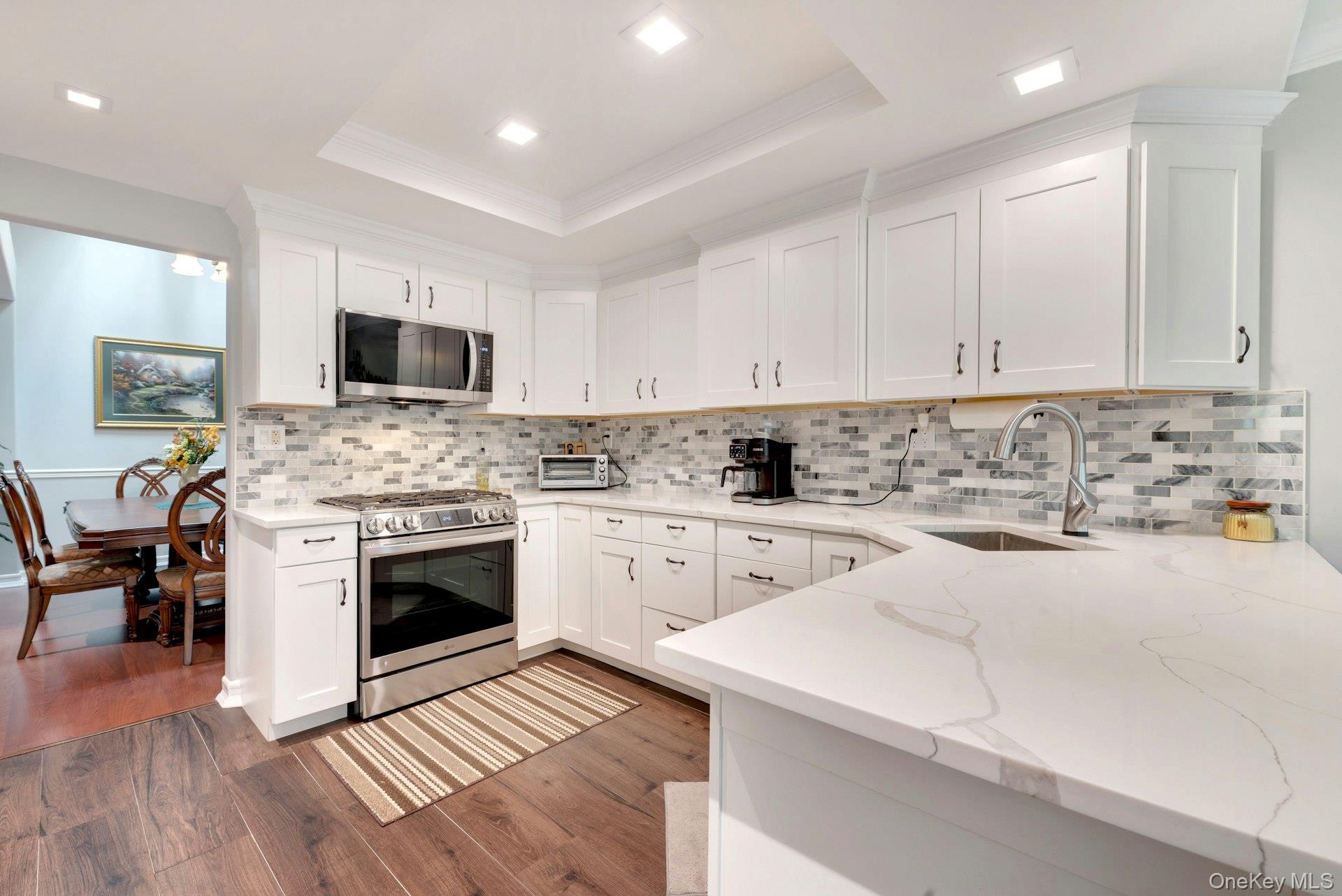 104 Glen Drive Ridge, NY 11961 - Photo 15 of 25 a kitchen with a sink stove top oven and cabinets