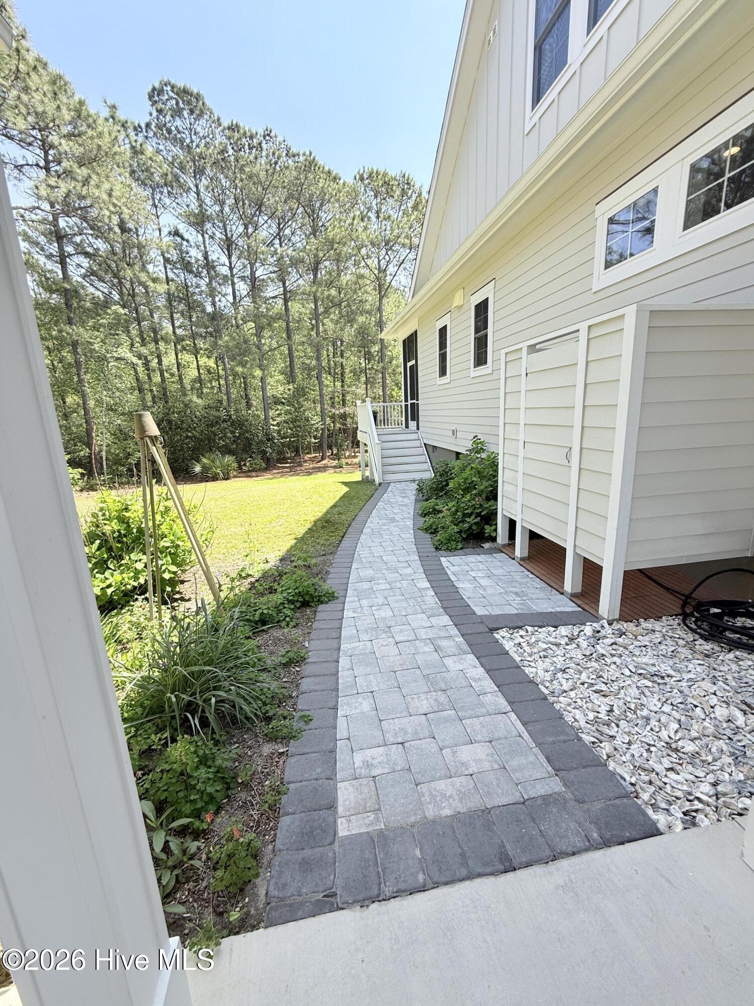 211 Whimbrel Way Hampstead, NC 28443 - Photo 61 of 99 Walkway leads to outdoor shower and back porch