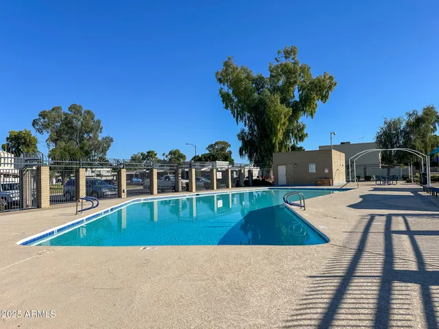 a view of a swimming pool with a lounge chair