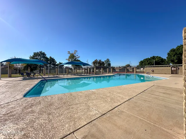 a view of a swimming pool with a yard