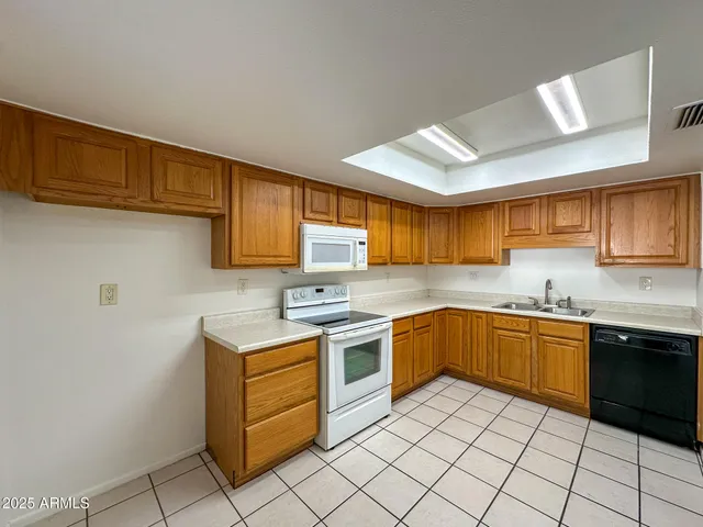 a kitchen with a stove sink and cabinets