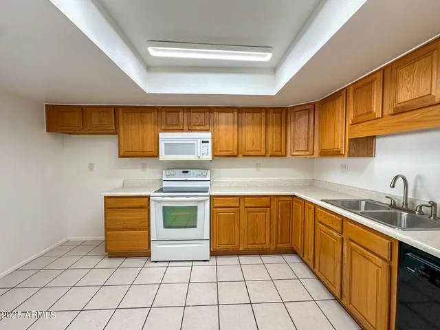 a kitchen with stainless steel appliances a stove sink and cabinets