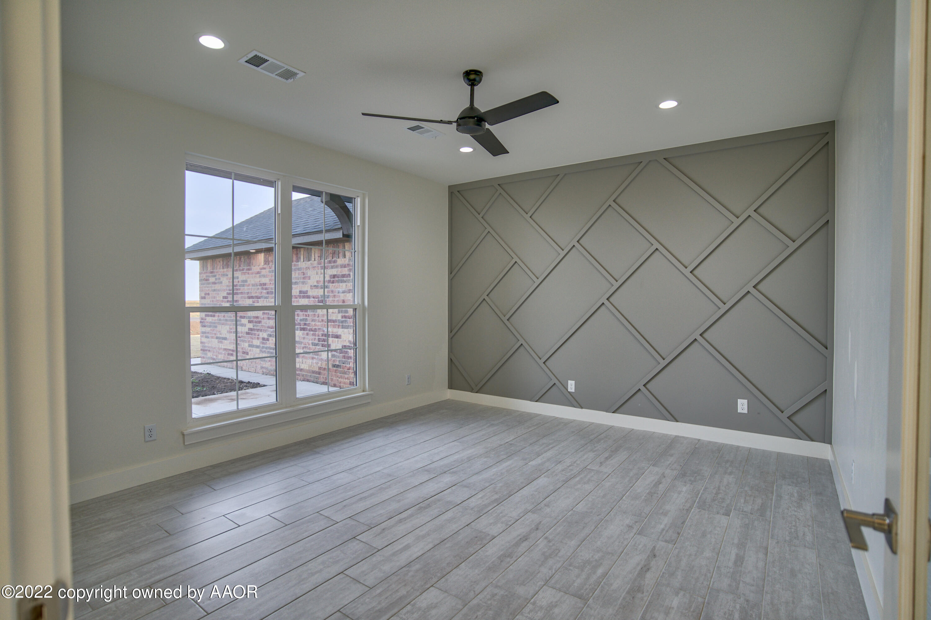 4200 Bobcat Springs Road Amarillo, TX 79119 - Photo 14 of 66 an empty room with wooden floor and windows