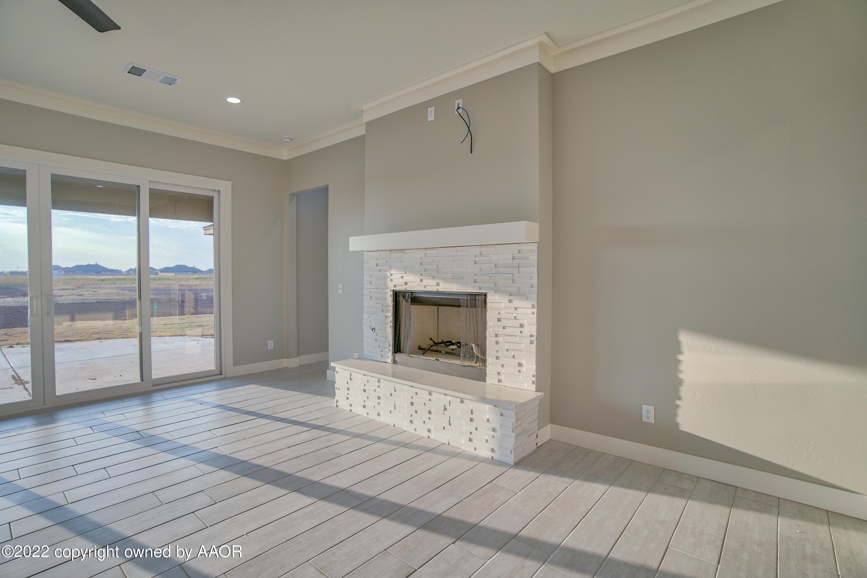 4200 Bobcat Springs Road Amarillo, TX 79119 - Photo 26 of 66 a view of an empty room with a fireplace and a window