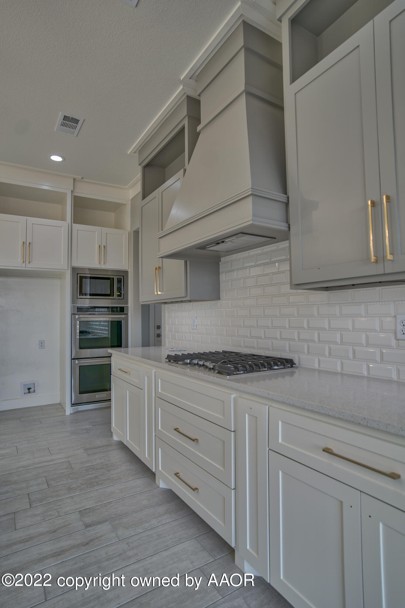 4200 Bobcat Springs Road Amarillo, TX 79119 - Photo 33 of 66 a kitchen with stainless steel appliances granite countertop a stove and white cabinets