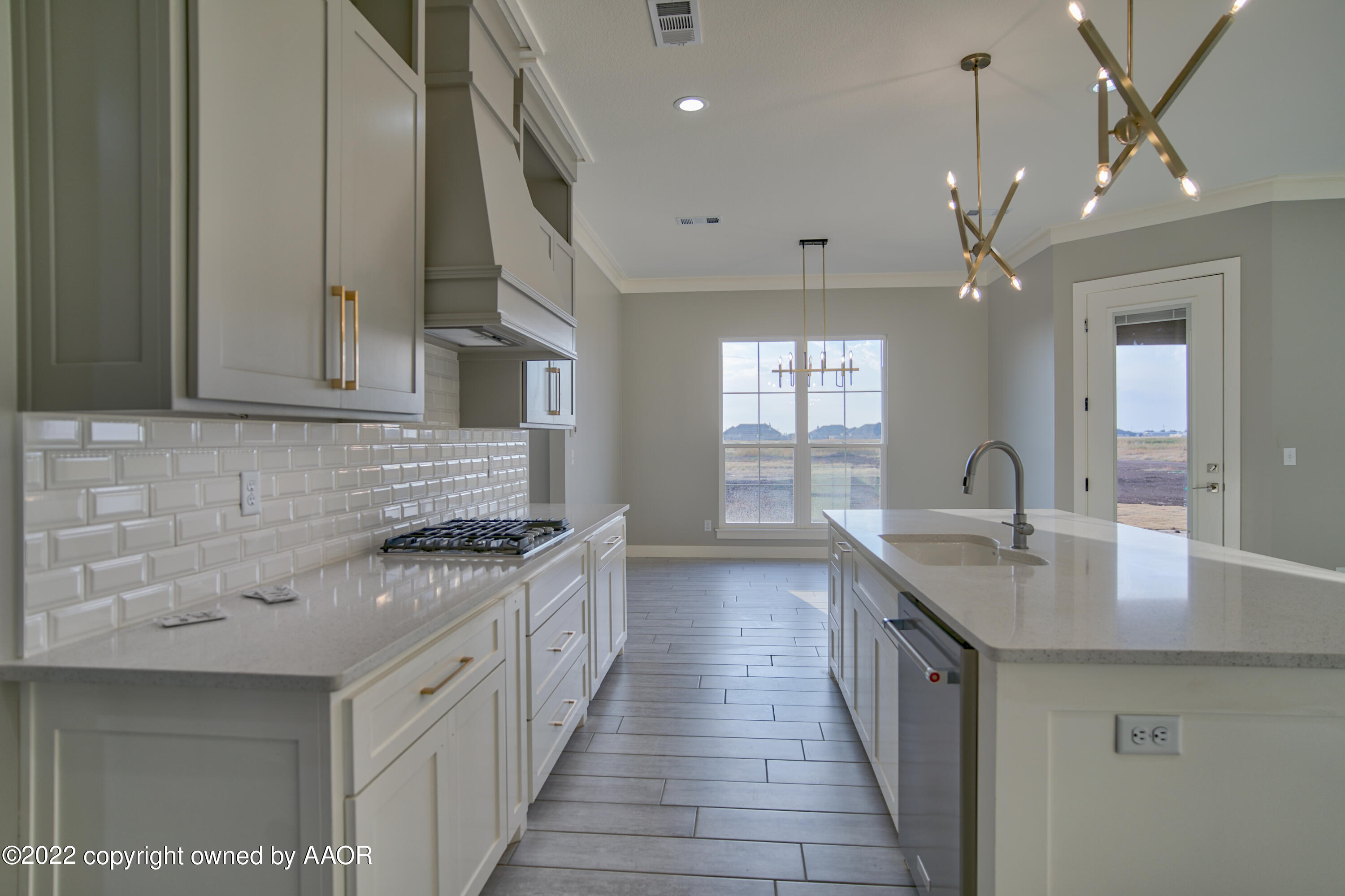 4200 Bobcat Springs Road Amarillo, TX 79119 - Photo 36 of 66 a kitchen with stainless steel appliances granite countertop a sink a stove and a wooden floors