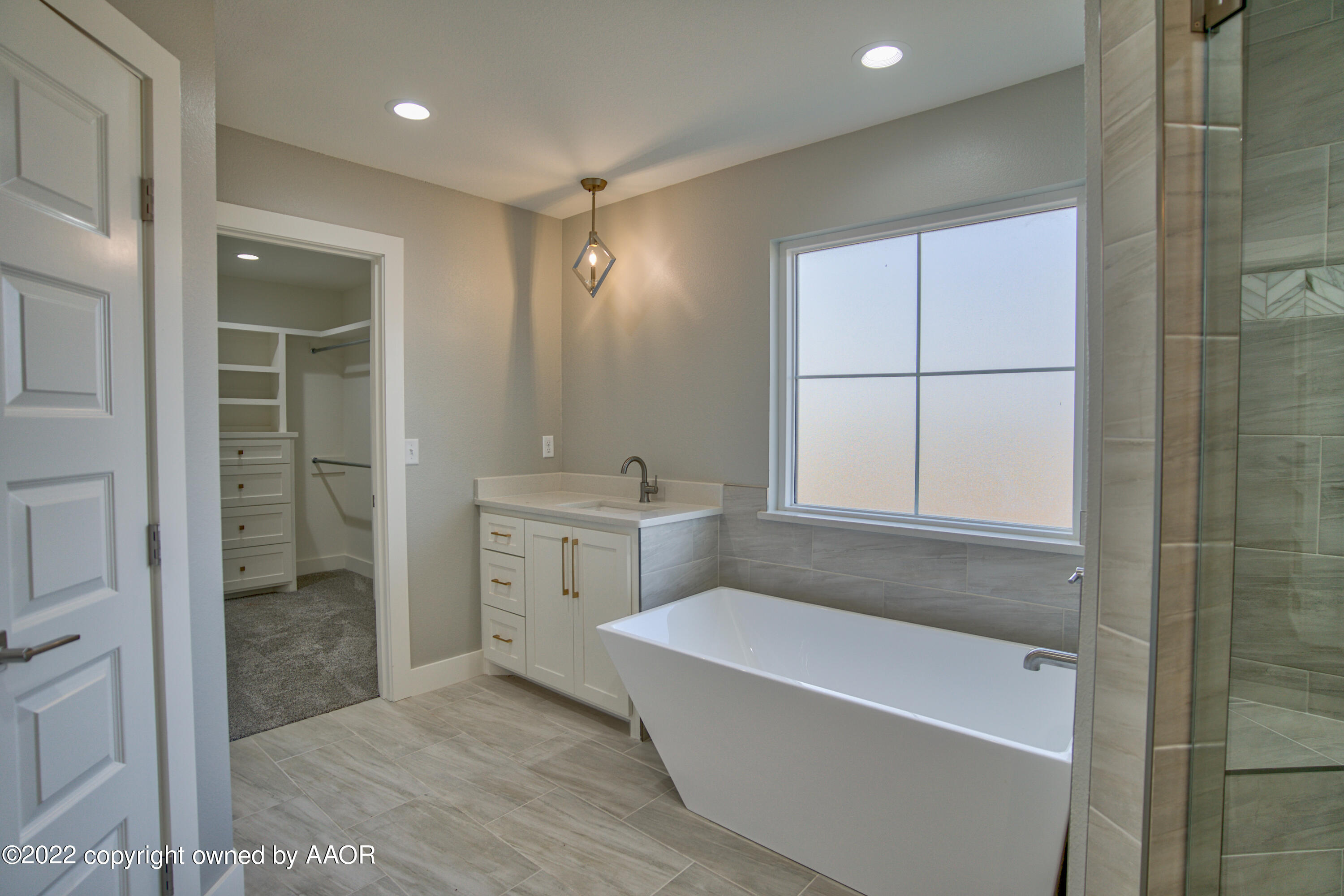 4200 Bobcat Springs Road Amarillo, TX 79119 - Photo 56 of 66 a bathroom with a bathtub a shower a sink and mirror