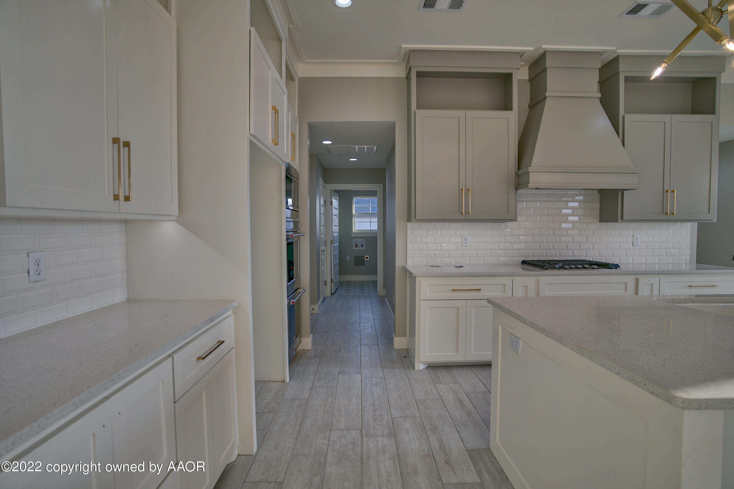 4200 Bobcat Springs Road Amarillo, TX 79119 - Photo 60 of 66 a kitchen with a sink cabinets and wooden floor