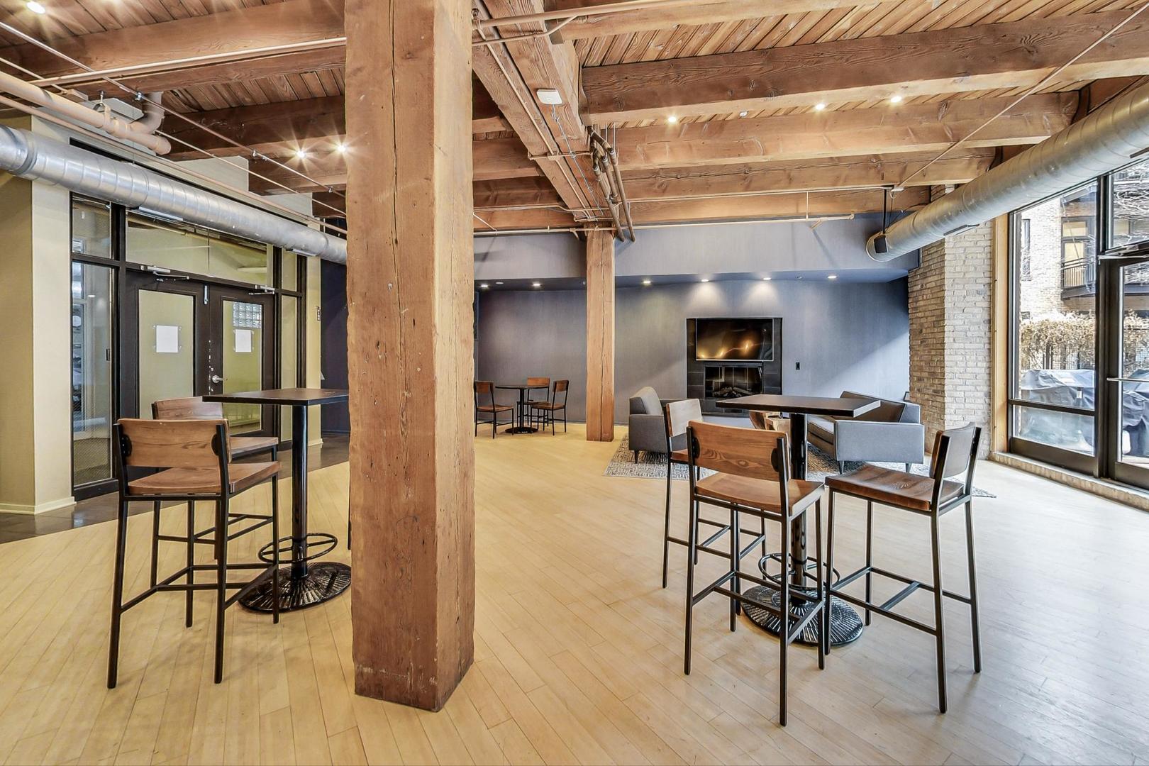 1040 West Adams Street, Unit 222 Chicago, IL 60607 - Photo 15 of 20 a view of a dining room with furniture and a chandelier