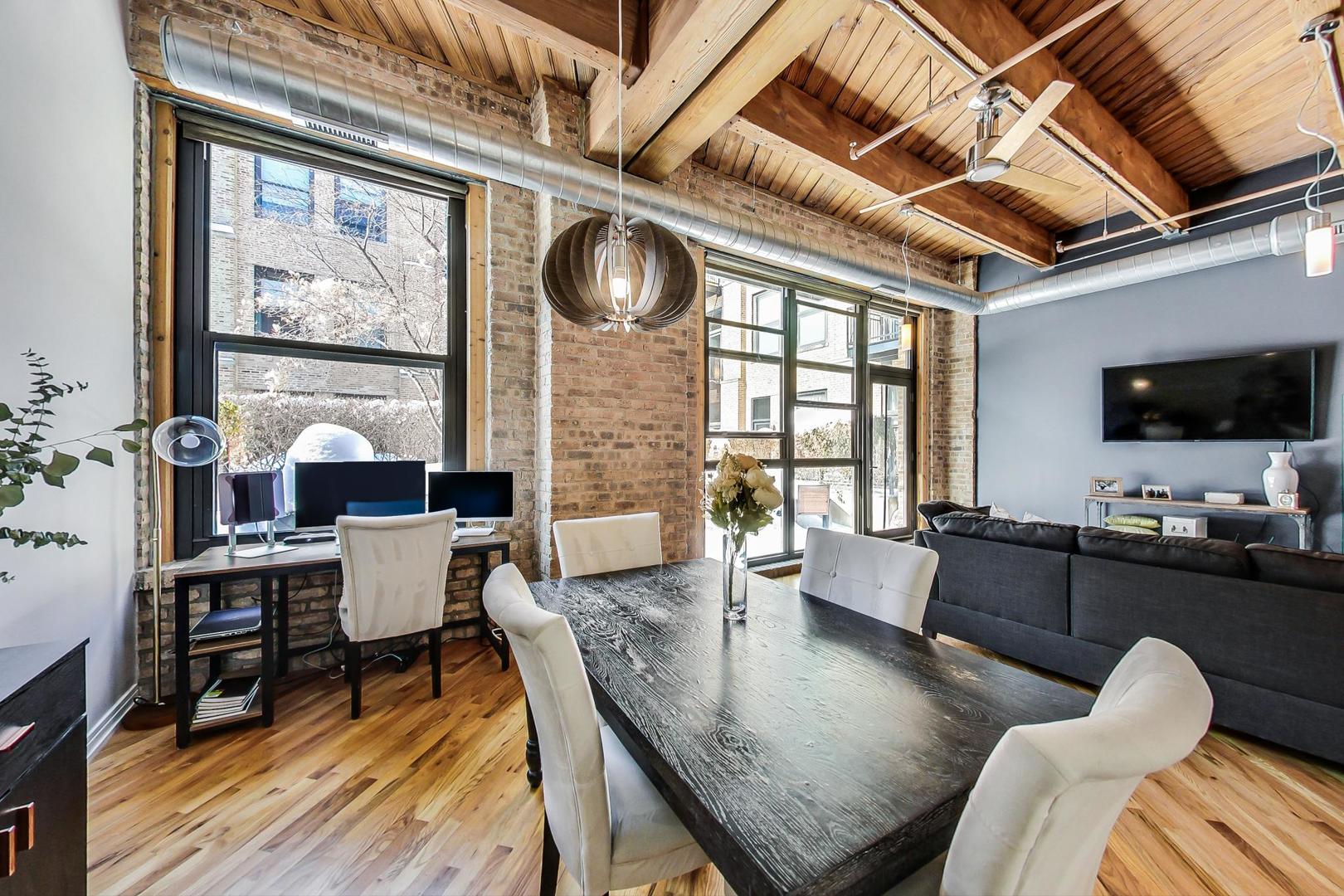 1040 West Adams Street, Unit 222 Chicago, IL 60607 - Photo 5 of 20 a living room with fireplace furniture and a flat screen tv