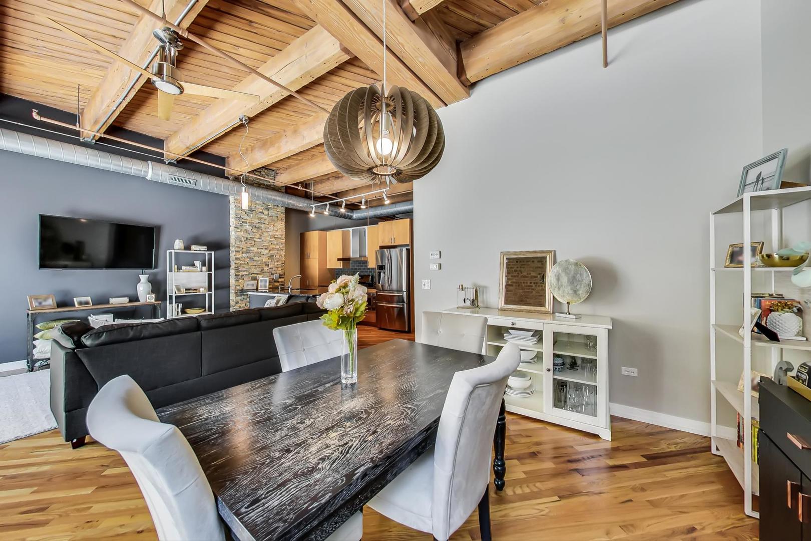 1040 West Adams Street, Unit 222 Chicago, IL 60607 - Photo 6 of 20 a living room with furniture and a flat screen tv