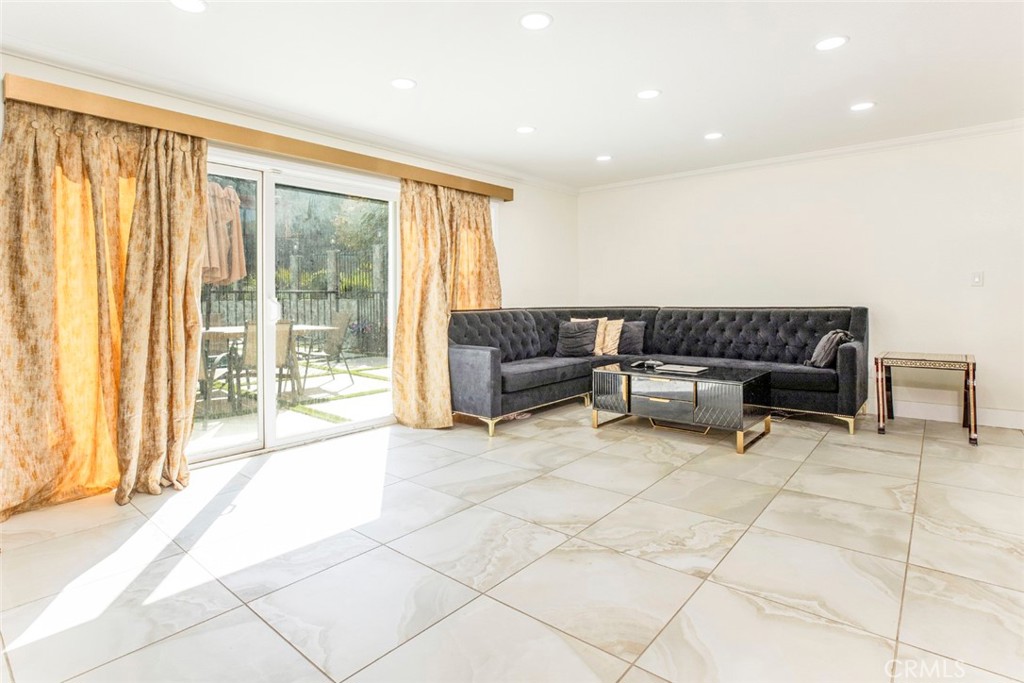 18810 Kirkcolm Lane Porter Ranch, CA 91326 - Photo 22 of 75 a living room with furniture and a floor to ceiling window