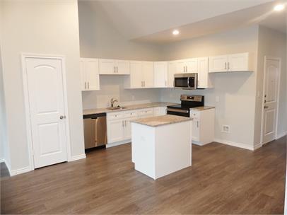 8071 County Road, Unit 436 Princeton, TX 75407 - Photo 1 of 8 a kitchen with a white cabinets a sink a stove a refrigerator and white cabinets
