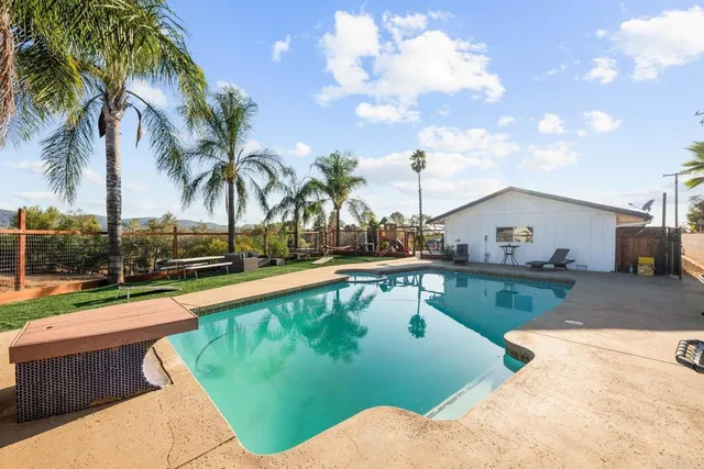 a view of swimming pool with outdoor seating and plants
