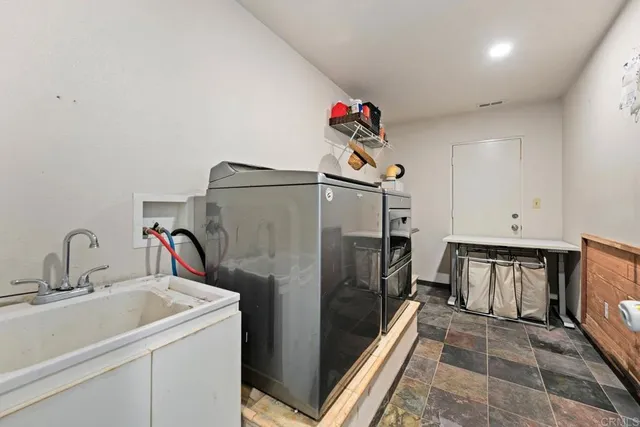 a view of a hallway with wooden floor and furniture