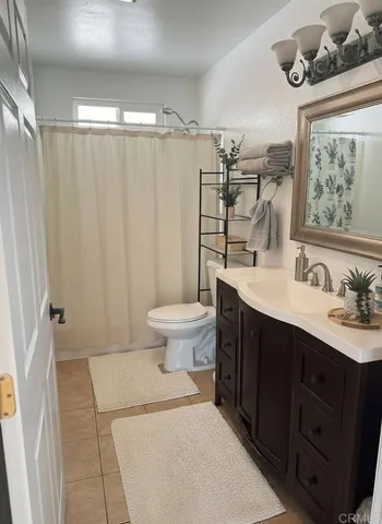 a bathroom with a sink a toilet and mirror