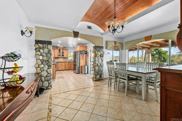 a view of a room with lots of furniture and a chandelier