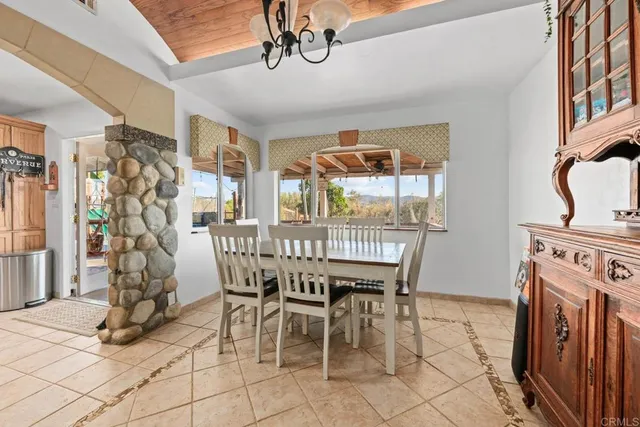 a dining room with furniture and window