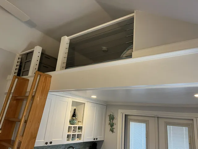 a large bed sitting in a bedroom next to a window