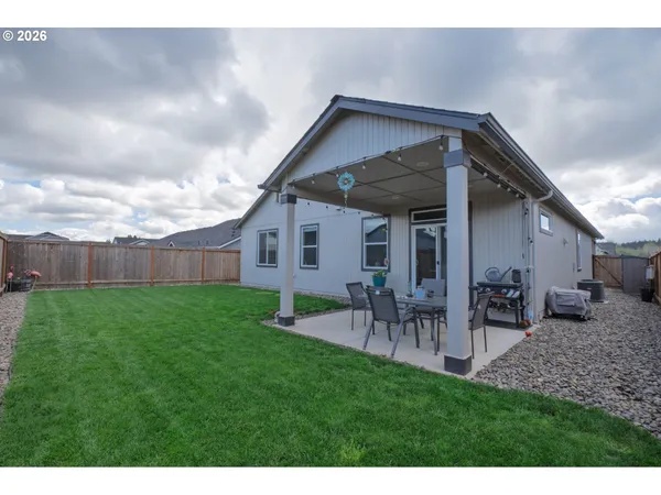 a living room with stainless steel appliances kitchen island granite countertop furniture and a large mirror