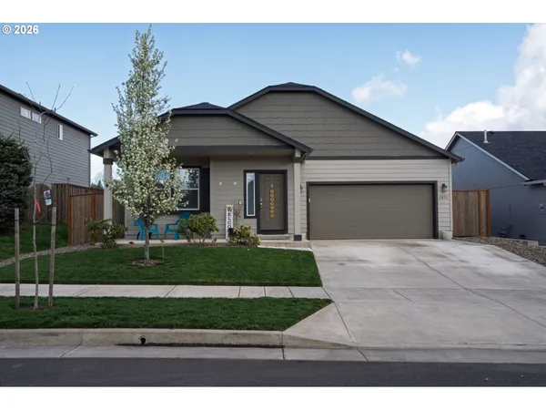 a front view of a house with a yard and garage