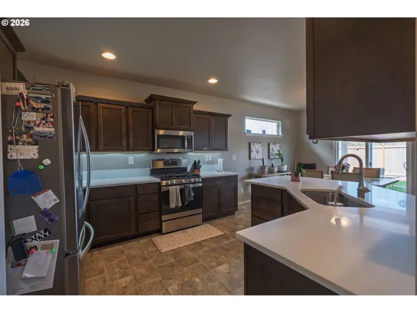 a kitchen with refrigerator and cabinets