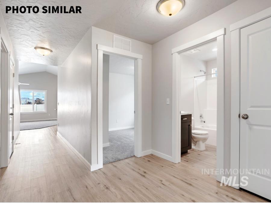 925 Twilight Weiser, ID 83672 - Photo 3 of 31 Hallway featuring wood-finish flooring and light-toned walls