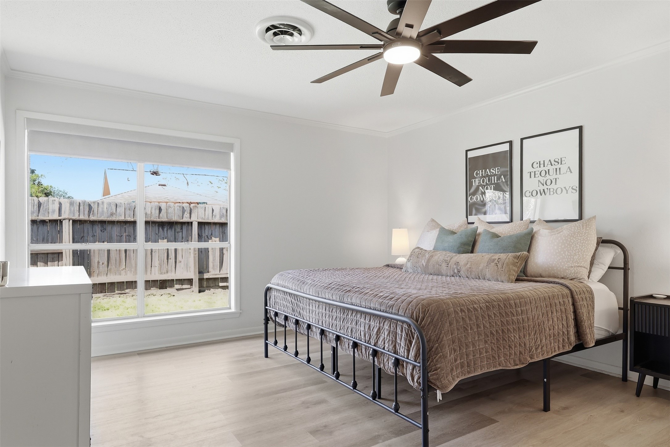 118 Santa Fe Victoria, TX 77904 - Photo 22 of 42 a bedroom with a bed a window and a chandelier