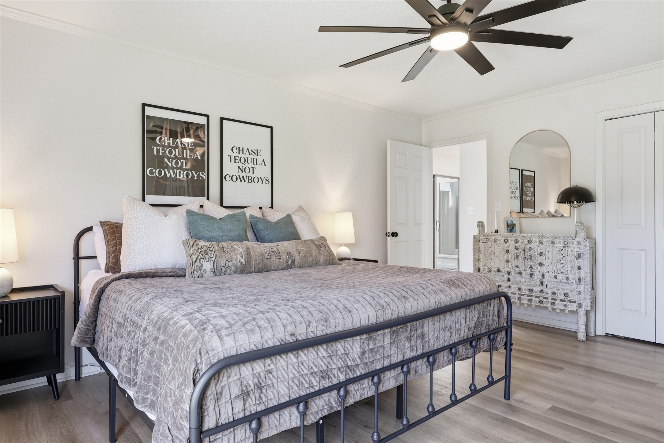 118 Santa Fe Victoria, TX 77904 - Photo 23 of 42 a bedroom with a large bed and a chandelier