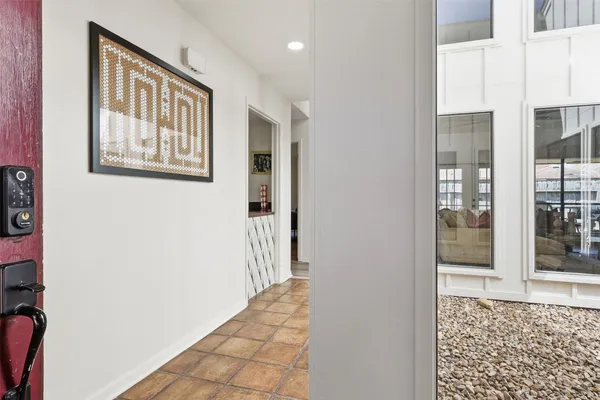 a kitchen with stainless steel appliances kitchen island granite countertop a table chairs sink and cabinets