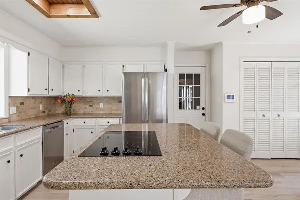a living room with furniture a window and a chandelier
