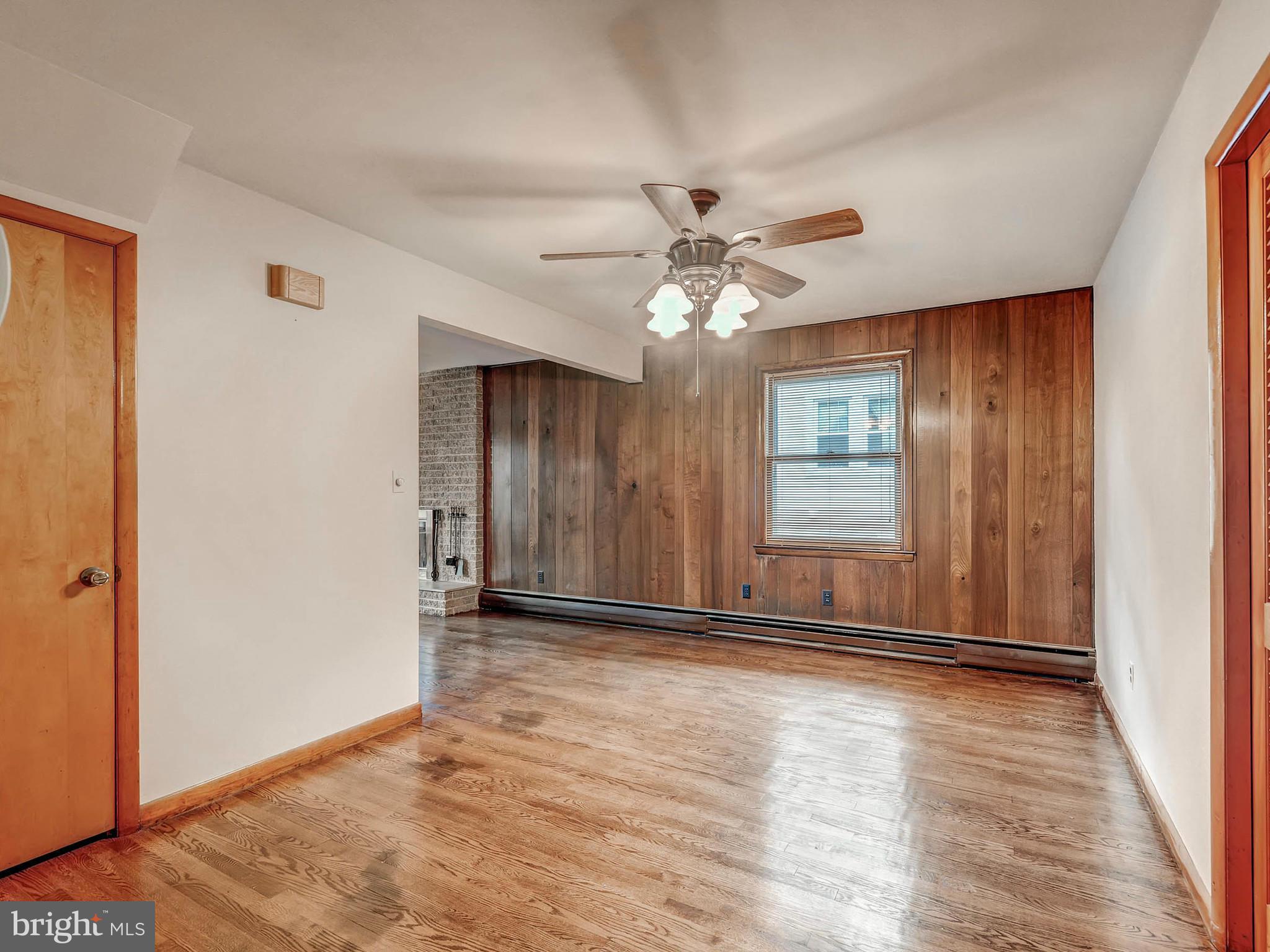 7306 Manchester Road Baltimore, MD 21222 - Photo 11 of 24 wooden floor in an empty room with a window