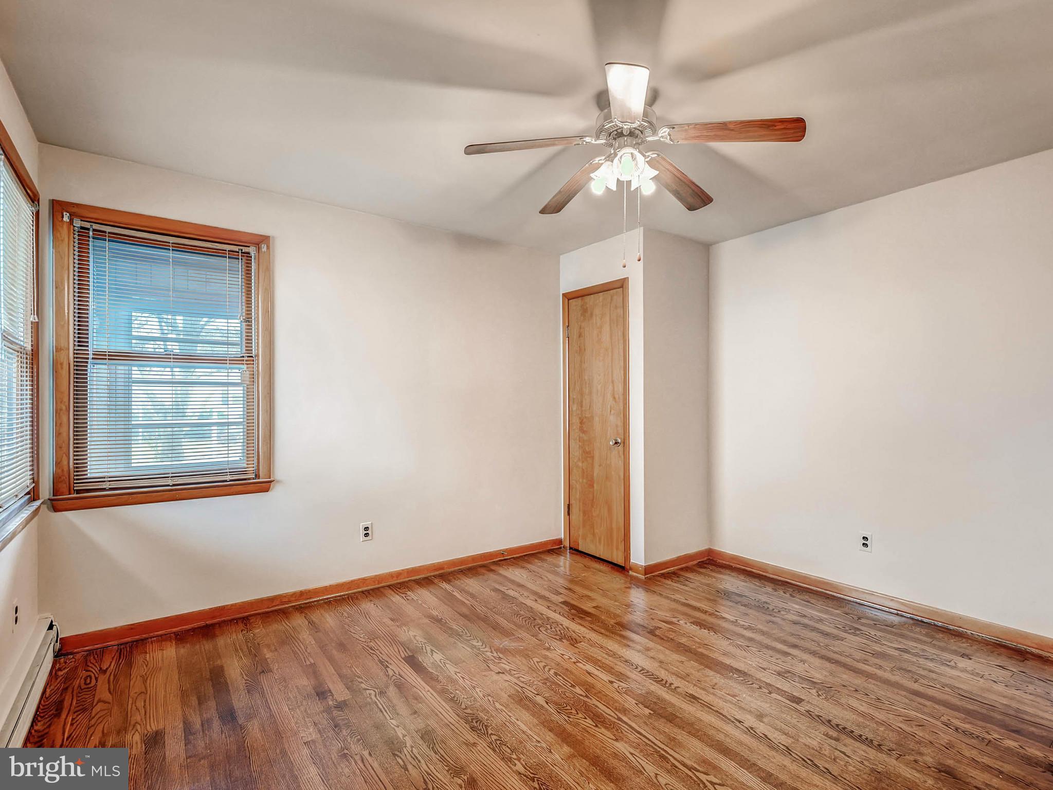 7306 Manchester Road Baltimore, MD 21222 - Photo 13 of 24 a view of an empty room with wooden floor and a window