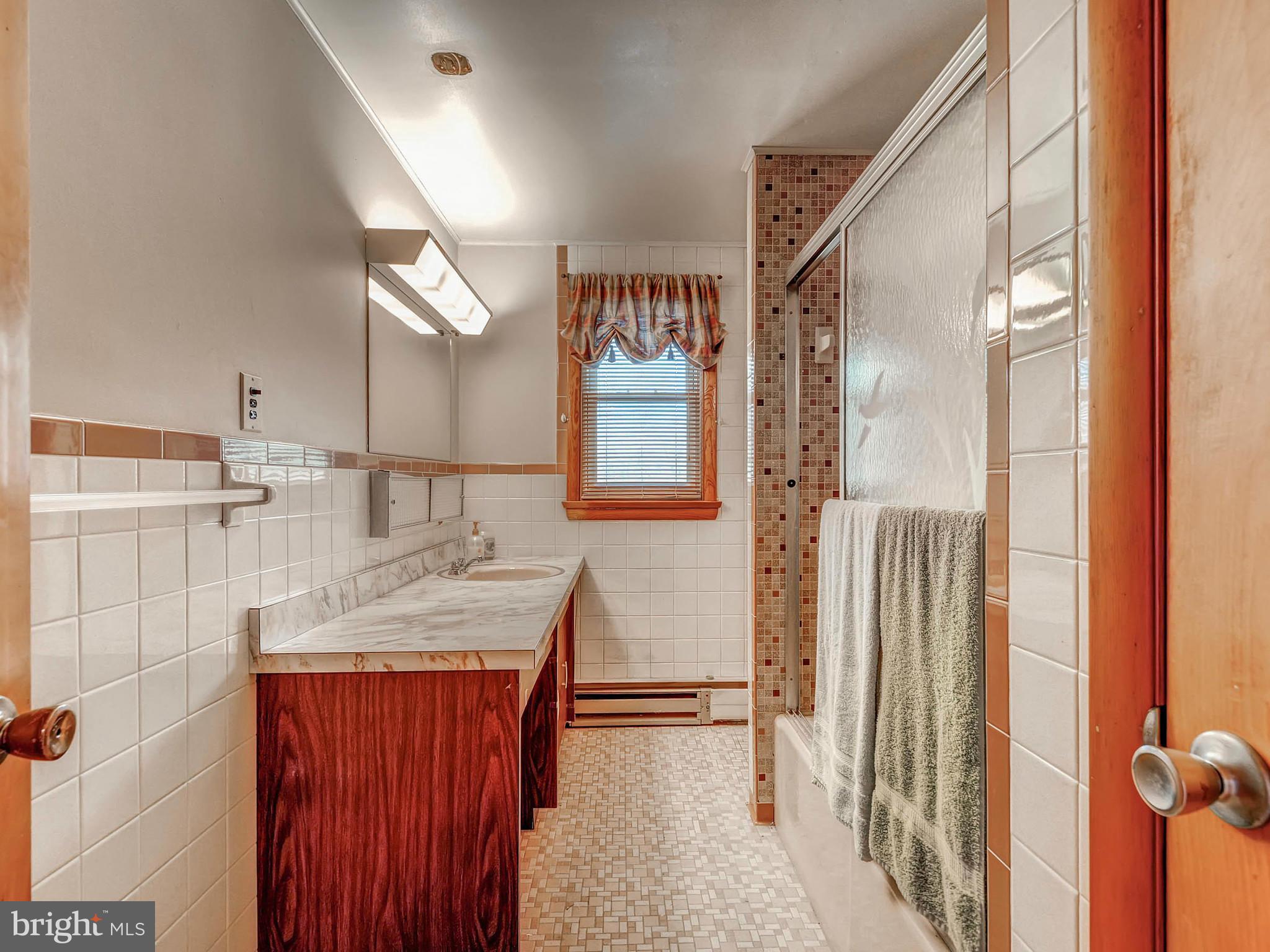 7306 Manchester Road Baltimore, MD 21222 - Photo 15 of 24 a bathroom with a granite countertop sink and a mirror