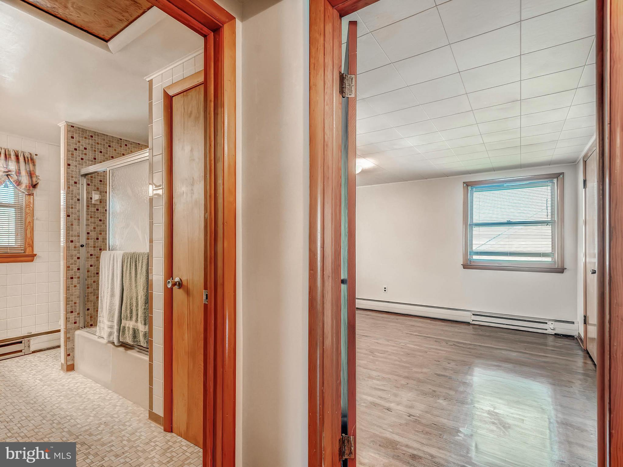 7306 Manchester Road Baltimore, MD 21222 - Photo 19 of 24 a view of a livingroom with wooden floor and a bathroom