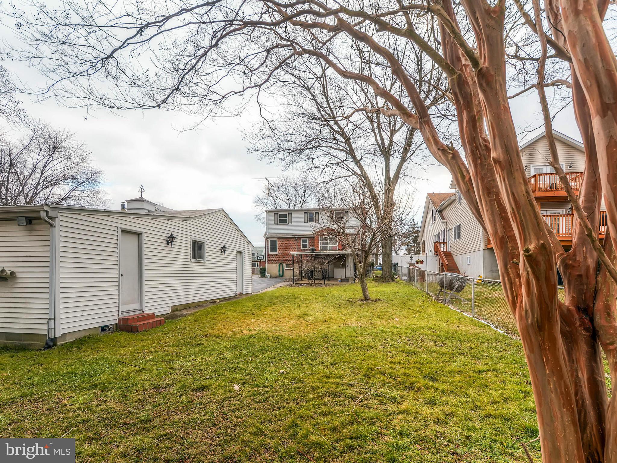 7306 Manchester Road Baltimore, MD 21222 - Photo 22 of 24 a view of a backyard with a large tree