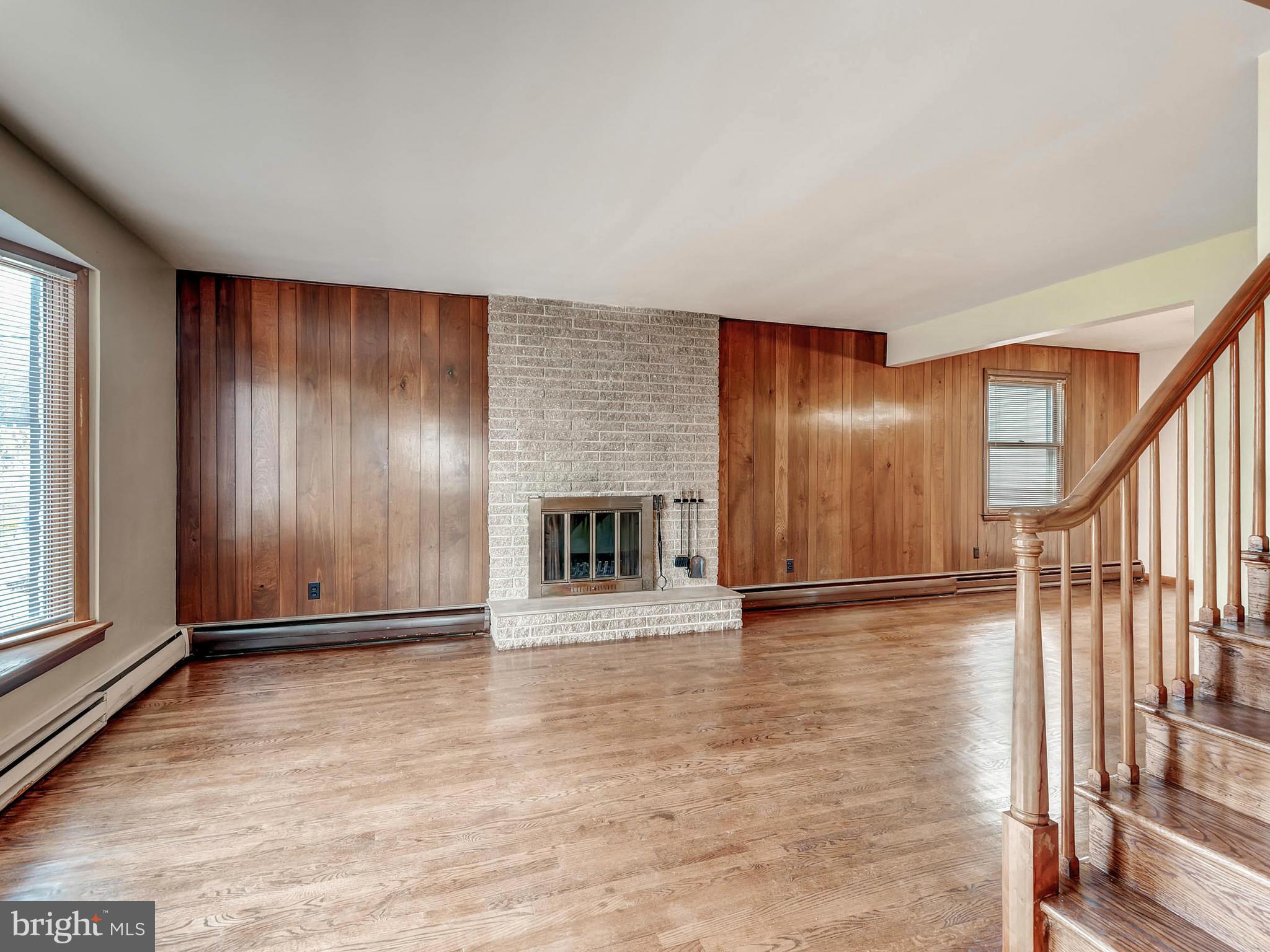 7306 Manchester Road Baltimore, MD 21222 - Photo 6 of 24 a view of an empty room with wooden floor and a window