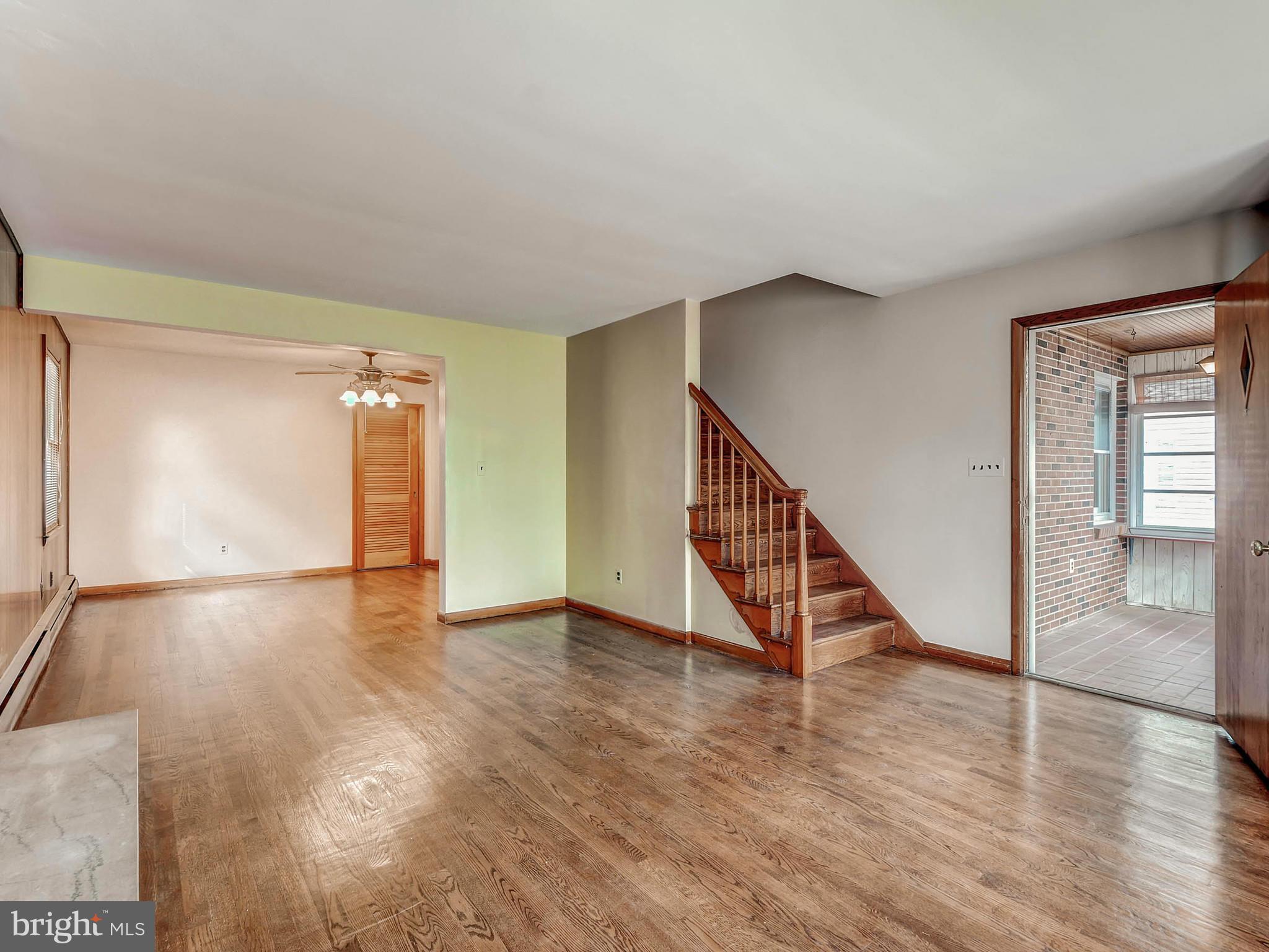 7306 Manchester Road Baltimore, MD 21222 - Photo 7 of 24 a view of an empty room with wooden floor and stairs